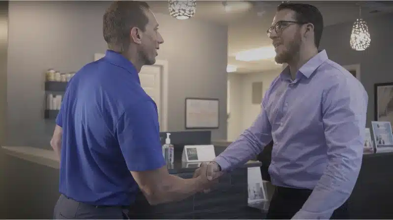 Video image that shows a handshake between Dustin and Dr Adam