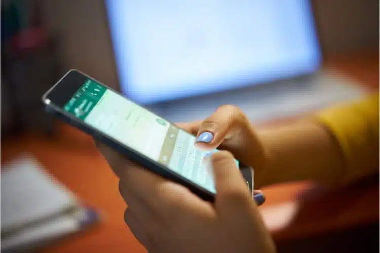 Man using whatsapp to personalized a message on mobile phone.