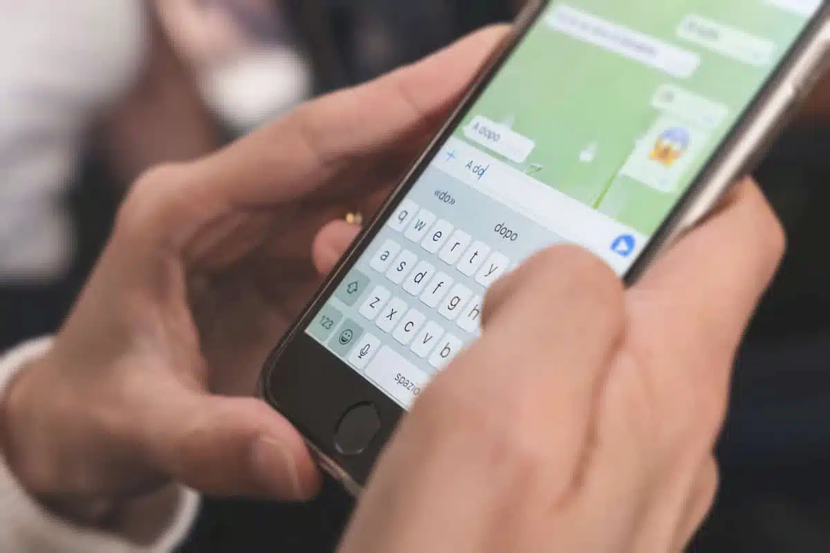 Woman using whatsapp on her smart phone device to deliver message.