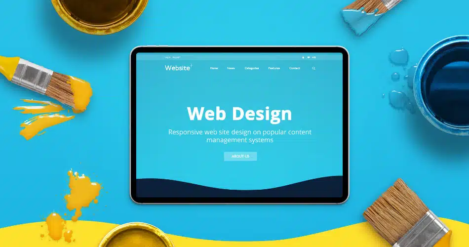Laptop screen with a web design concept on it in a blue background