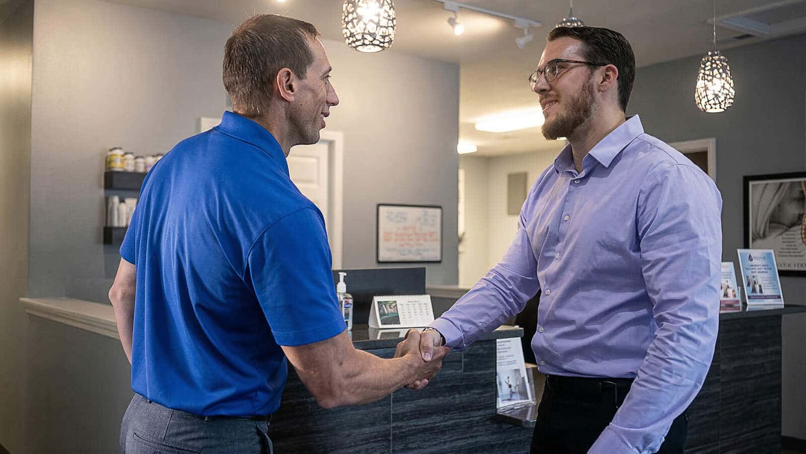 Video image that shows a handshake between Dustin and Dr Adam